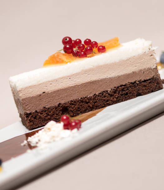 istock Fancy triple mousse chocolate dessert, decorated with forest fruits and chocolate sauce 1082336062