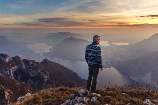 Man hiker solo on the mountain during golden hour