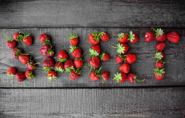 Sweet strawberry. Inscription from berries