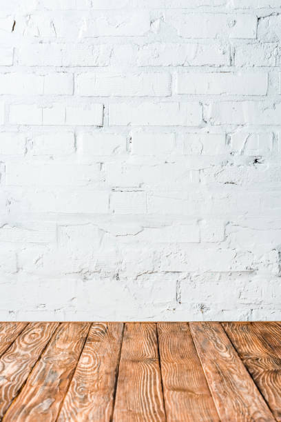 istock white brick wall and wooden table 1082339612