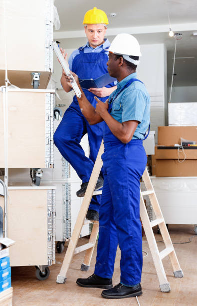 istock Two male builders working at indoors building site 1082342524