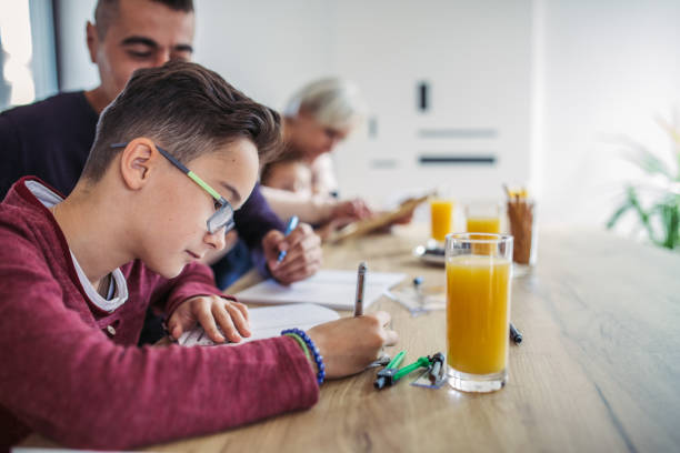 rodzice pomagający w odrabianiu lekcji - mixed age child love teamwork zdjęcia i obrazy z banku zdjęć