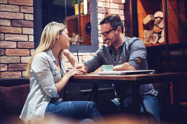 istock Young attractive couple flirting in cafe. 1082349418