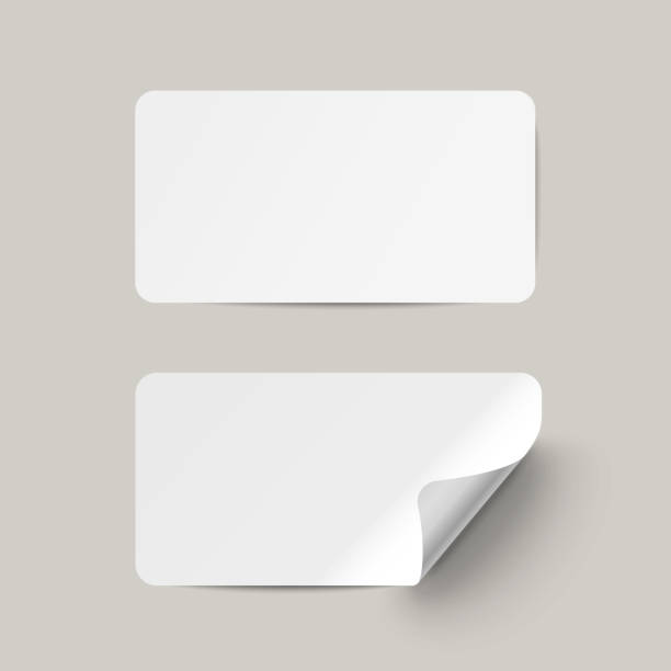 istock Vector white realistic paper adhesive stickers with curved corneron transparent background. 1082349752