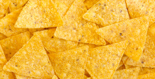 Tortilla chips, closeup. Mexican food. Top view, flat lay, overhead. Tortilla chips, closeup. Mexican food. Top view, flat lay, overhead. tortilla chip stock pictures, royalty-free photos & images