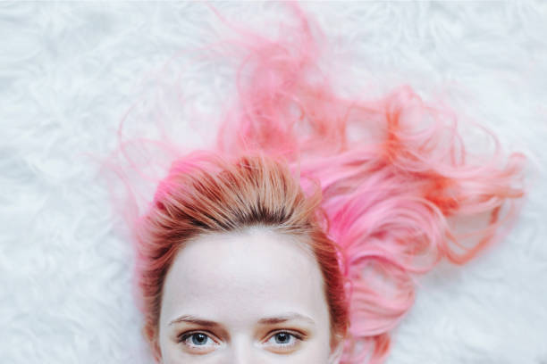 Modern young woman with pastel pink hair stock photo