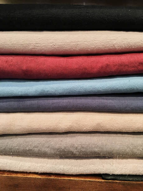 istock Bunch of knitted warm pastel color different knitting patterns in stack on white. Fall winter season fashionable knitwear. 1082352694