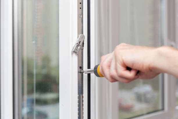 istock Handyman repairs plastic window with screwdriver 1082357716