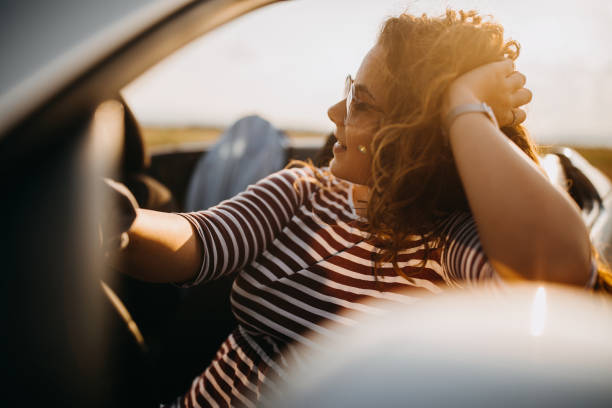 istock Young women on a road trip with cabriolet 1082359760