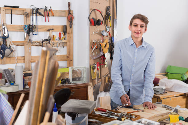 istock young pupil working with  wood plank in class 1082360214