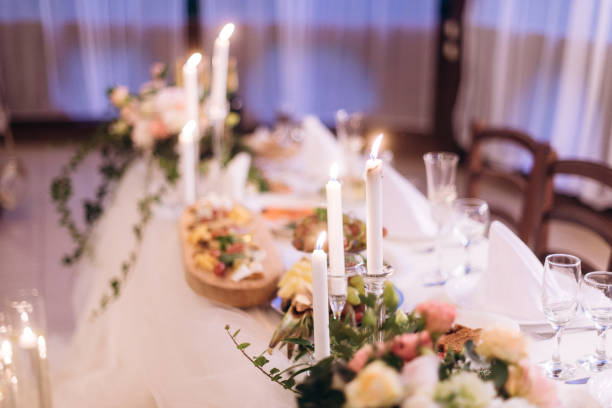 istock candles floating in stemware and roses for wedding reception 1082362432