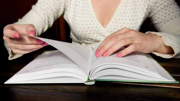 istock Turns the pages of the book 1082364126