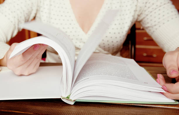 istock Turns the pages of the book 1082364132