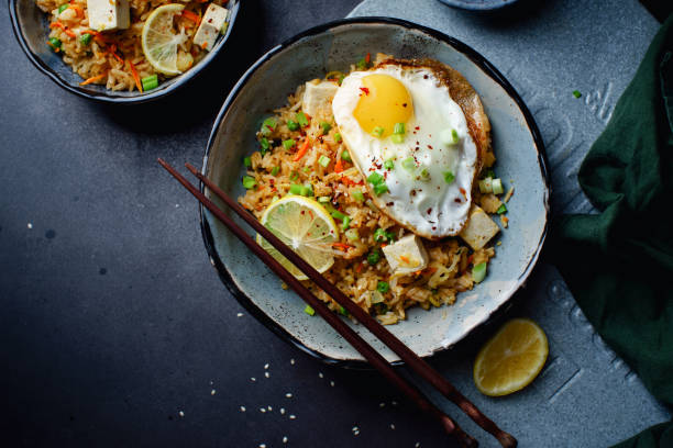 Vegetarian fried rice with tofu, peas and vegetables. Asian cuisine, healthy lunch Vegetarian fried rice with tofu, peas and vegetables. Asian cuisine, healthy lunch fried rice stock pictures, royalty-free photos & images