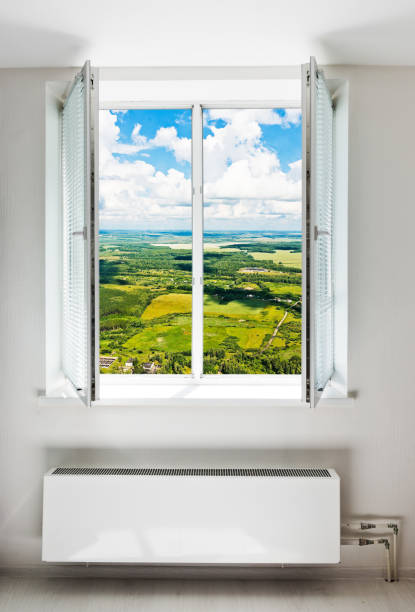 istock White open double door window with radiator under it. 1082389148
