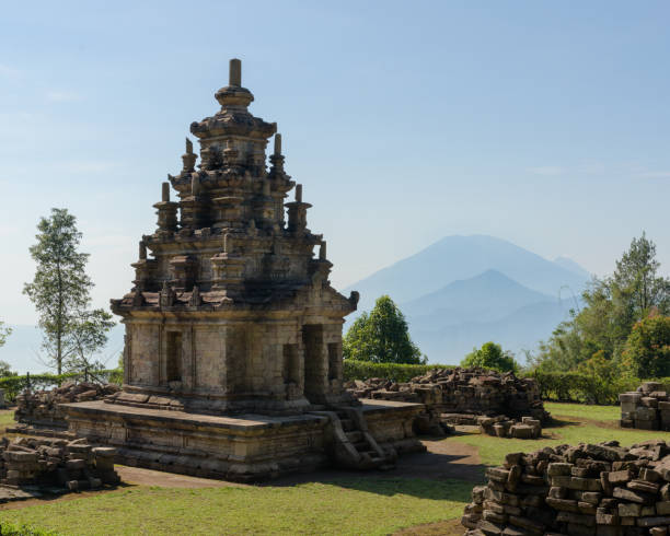 istock Candi Gedong Songo at sunrise. A 9th-century Buddhist temple complex with Mounts Merbabu and Merapi. 1082393512