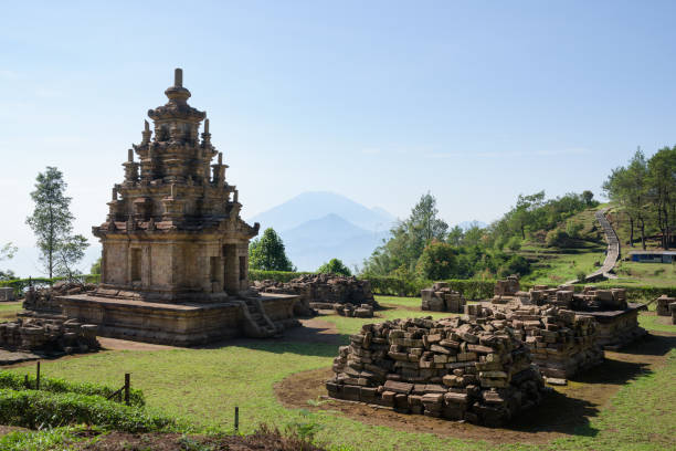 istock Candi Gedong Songo at sunrise. A 9th-century Buddhist temple complex with Mounts Merbabu and Merapi. 1082393514