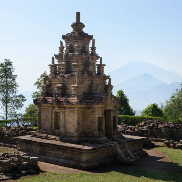 istock Candi Gedong Songo at sunrise. A 9th-century Buddhist temple complex with Mounts Merbabu and Merapi. 1082393522