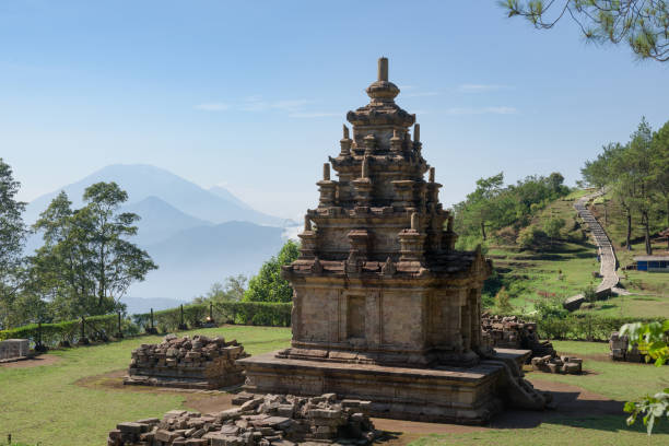 istock Candi Gedong Songo at sunrise. A 9th-century Buddhist temple complex with Mounts Merbabu and Merapi. 1082393526