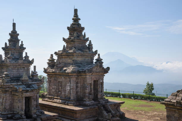 istock Candi Gedong Songo at sunrise. A 9th-century Buddhist temple complex with Mounts Merbabu and Merapi. 1082393534