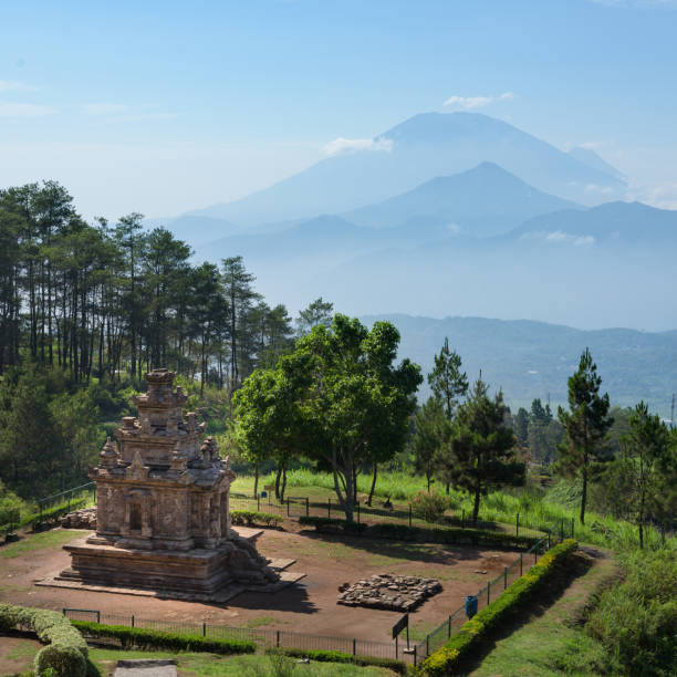 istock Candi Gedong Songo at sunrise. A 9th-century Buddhist temple complex with Mounts Merbabu and Merapi. 1082393538
