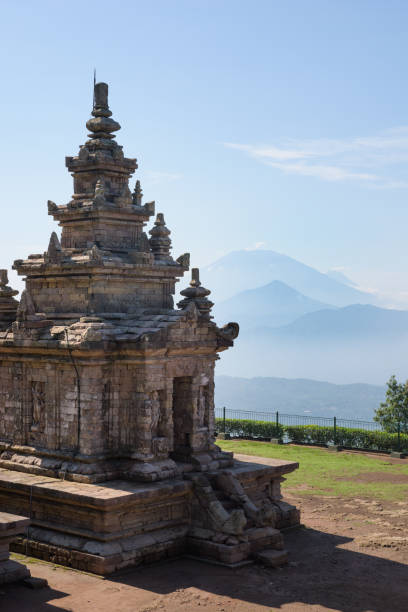istock Candi Gedong Songo at sunrise. A 9th-century Buddhist temple complex with Mounts Merbabu and Merapi. 1082393546