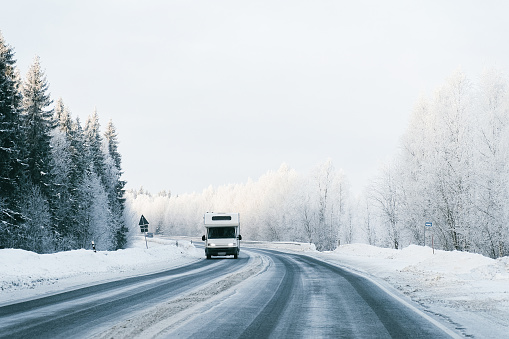 Caravan in a road at winter Rovaniemi, in Lapland in Finland. At snowfall