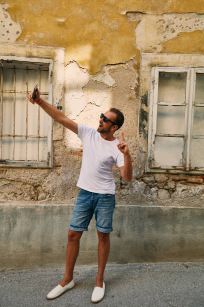 istock Modern guy using cellphone in the European city. 1082405424