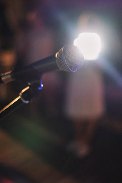 istock Microphone on stage. Microphone closeup in the club before the show 1082406812