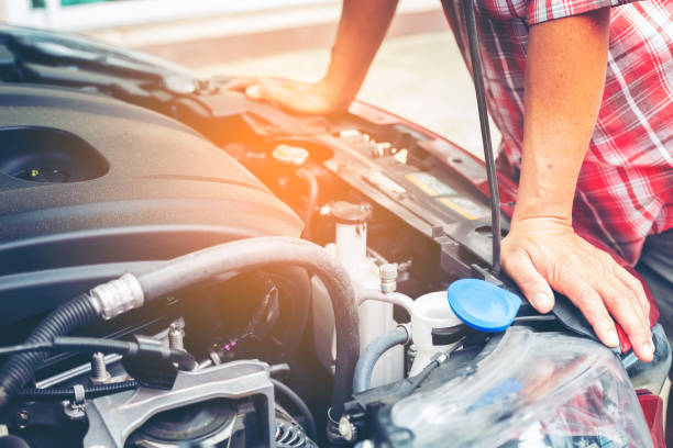 istock Midsection Of Man Standing By Car Engine On Road 1082409260