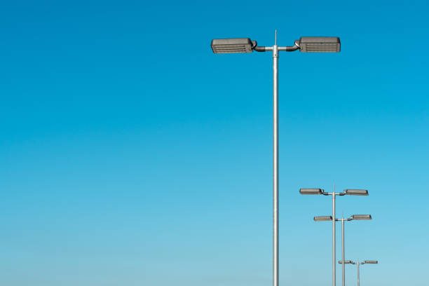 istock Low Angle View Of Street Lights Against Clear Blue Sky 1082409306