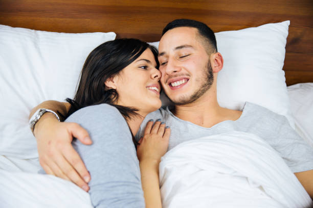 istock Young Couple in Bed Embracing. 1082411394