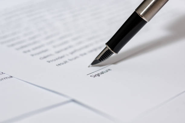 Close up business man signing contract