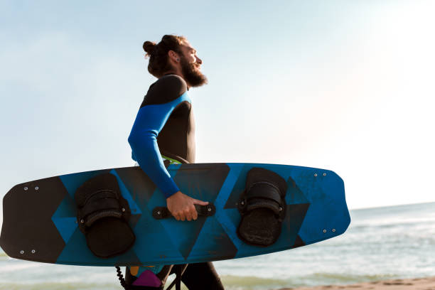 istock Photos Athletic man riding on kite surf board 1082414770