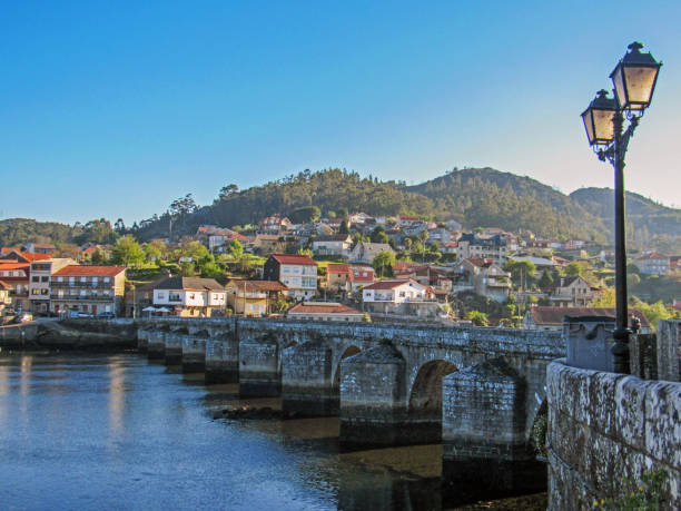istock View on medieval bridge through river and small mountain town with red tailed roofs, countryside Portugal 1082419742