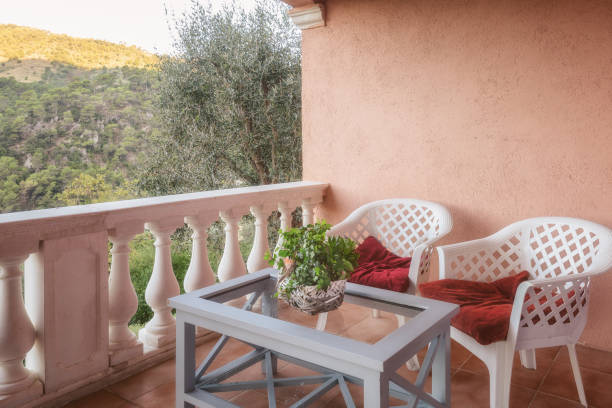 istock Two chairs with a table on the terrace overlooking the mountains and valley 1082426884