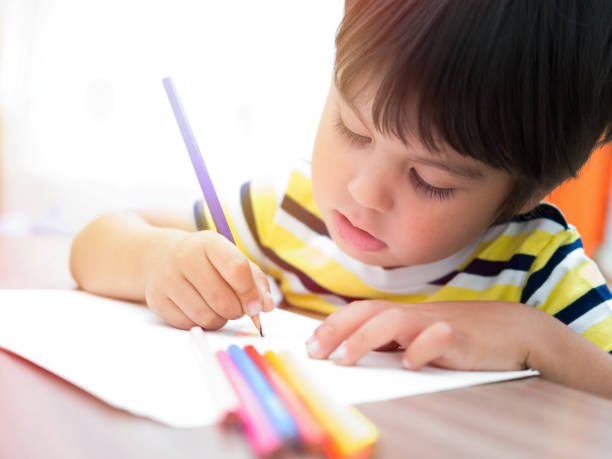 istock The child paints with colored pencils 1082429360