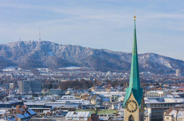 The city of Zurich in Switzerland as seen from the tower of the Grossmunster cathedral in winter The city of Zurich in Switzerland as seen from the tower of the Grossmunster cathedral in winter, tower of the famous Fraumunster cathedral in the foreground., Mt. Uetliberg in the background. switzerland zurich architecture church stock pictures, royalty-free photos & images