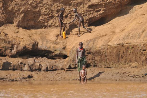 Life along Omo river Omorate, Ethiopia - January, 01, 2016:local people washing in the Omo river omo river photos stock pictures, royalty-free photos & images