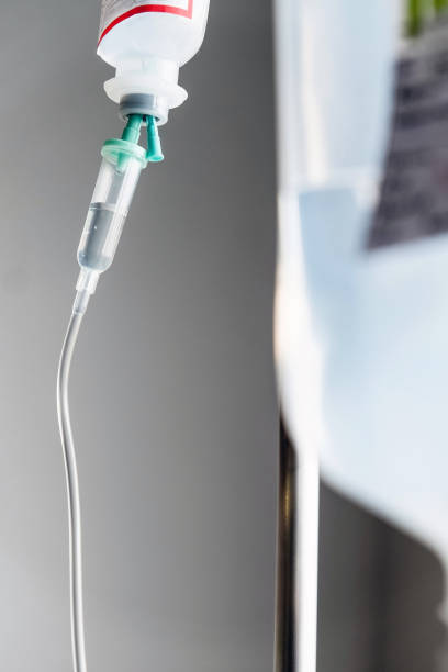 istock IV saline solution drip for patient in hospital 1082434178