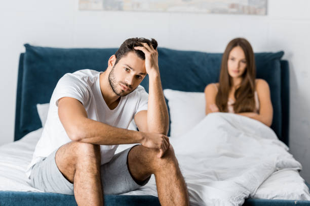 istock selective focus of sad man with sexual problems sitting in bed 1082434478