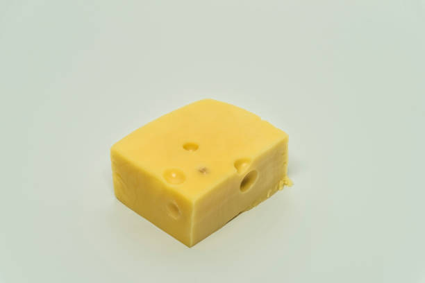 istock Yellow cheese with big holes and white background 1082437212