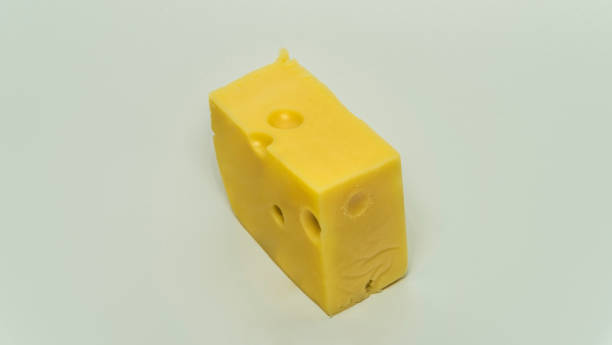istock Yellow cheese with big holes and white background 1082437270