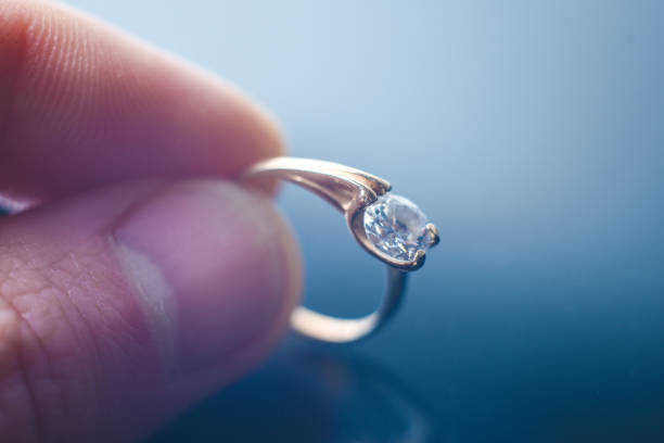 istock gold ring with jeweler in hand 1082441594