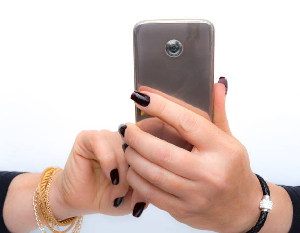 istock she is  taking a picture with her pink gold smartphone 1082442074