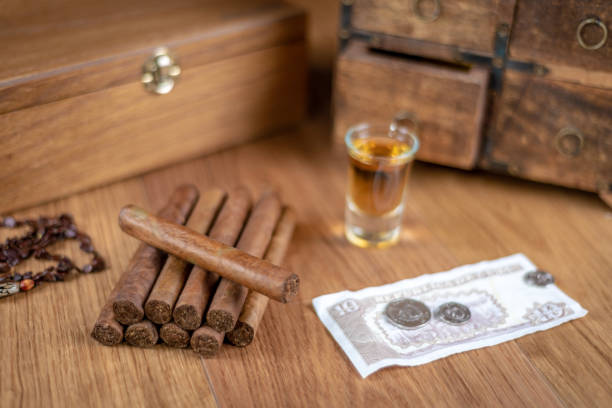 istock Cuban cigars with rum, currency and a humidor 1082450492