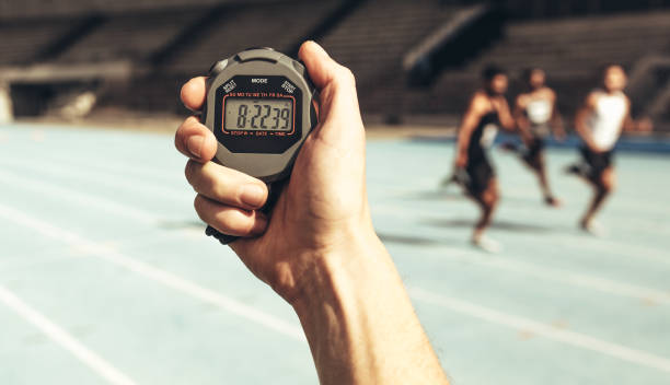 istock Man keeping time at a running race using stop watch 1082453396
