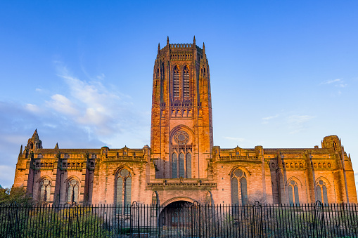 Stock photograph of the landmark Liverpool Cathedral in Liverpool England UK illuminated at sunrise.