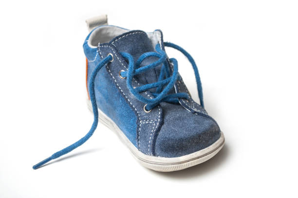 istock blue leather baby sneakers on white background 1082456622