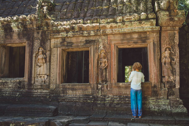 istock Rear View Of Mid Adult Woman Standing Outside Ankor Wat Temple 1082457504